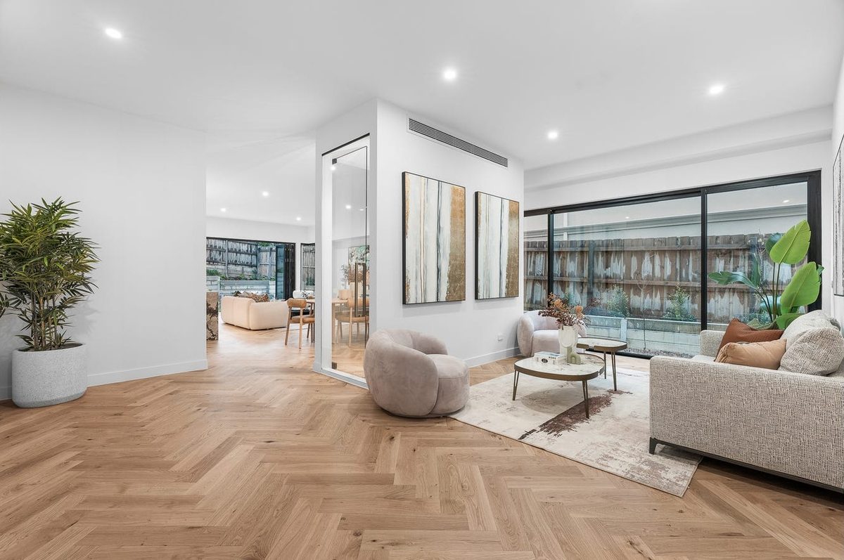 Living area with herringbone flooring and downlights