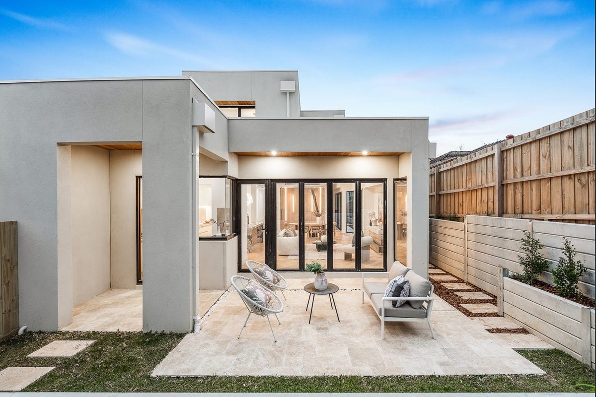 Home exterior courtyard opening onto bifold living doors