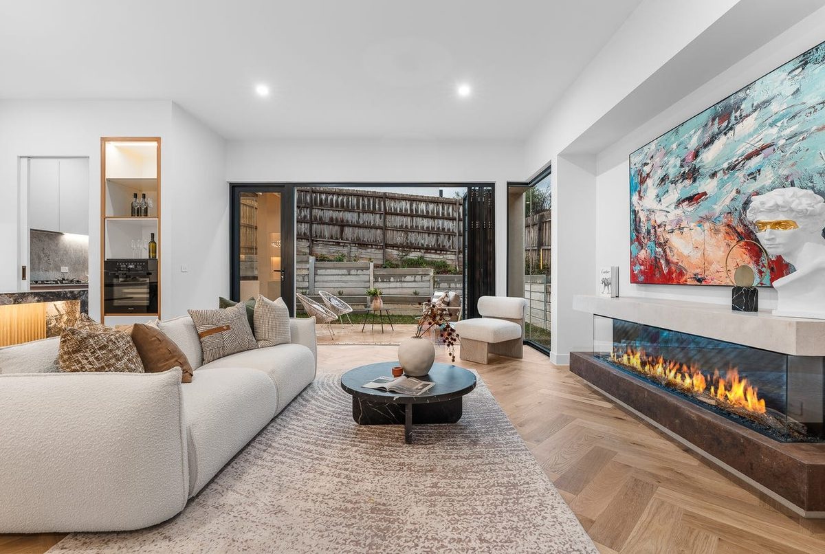 Living room with linear gas fireplace and feature lighting